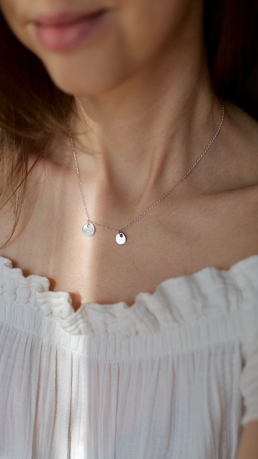 Handcrafted silver organic coin pendant necklace by Atelier Objectora, featuring a irregular medallion design, timeless and versatile

 Ručne vyrobený strieborný náhrdelník s organickým okrúhlym príveskom od Atelier Objectora, s nepravidelným medailónom, nadčasový a univerzálny