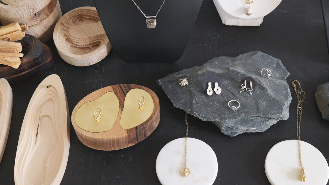 video showing various wooden art object and jewerly made by atelier objectora placed on dark backdrop
